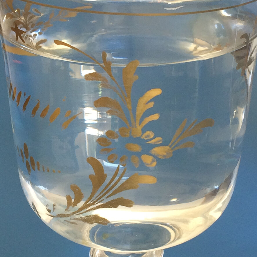 Two antique walking glasses with gold-painted floral decoration