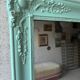 Large antique mercury mirror, patinated blue sculpted frame.