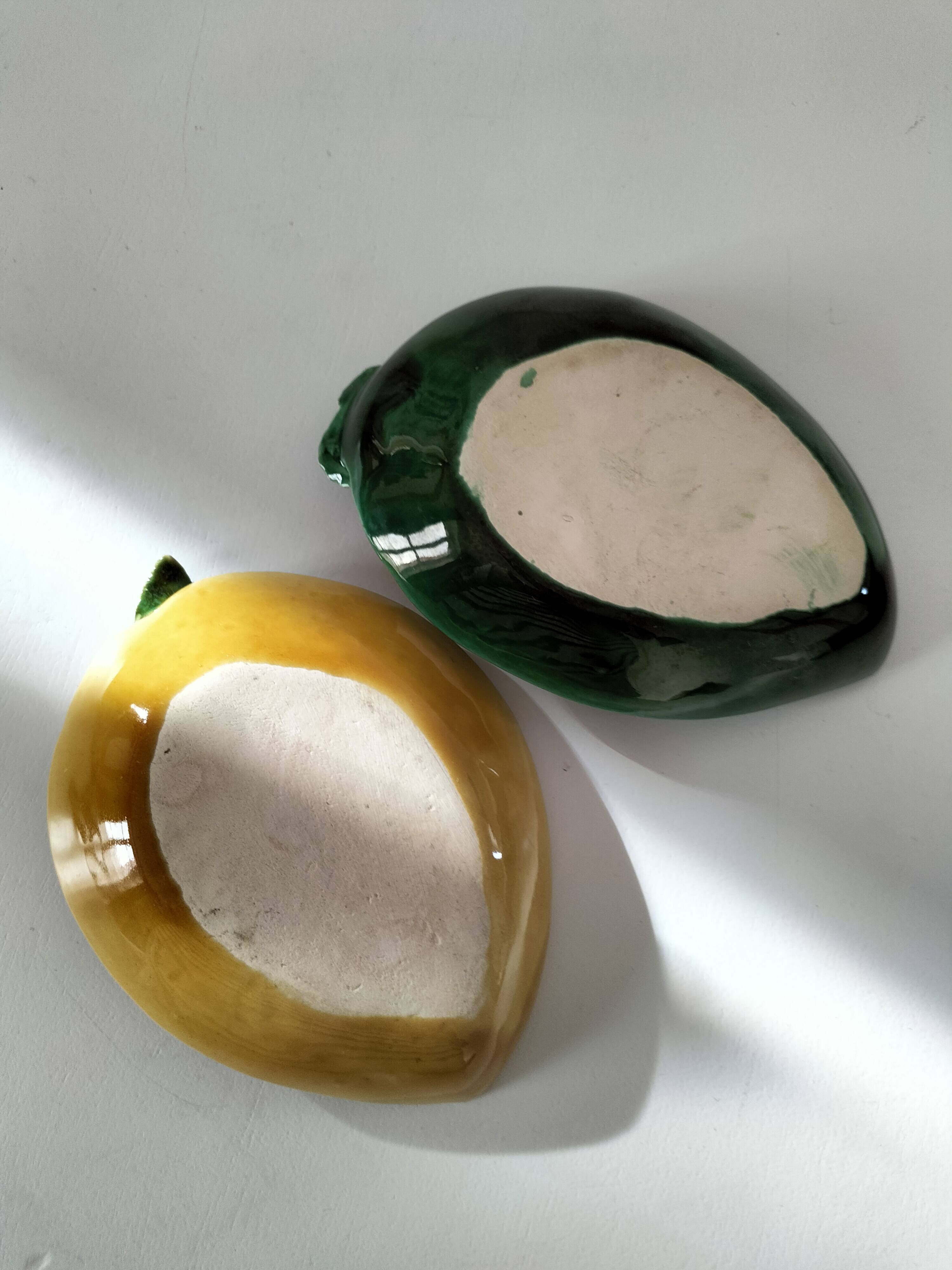 Two relief bowls with leaf designs, radishes, and tomatoes.