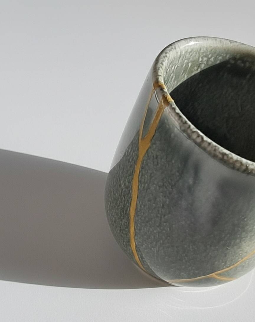 A pair of artisanal cups in traditional kintsugi.