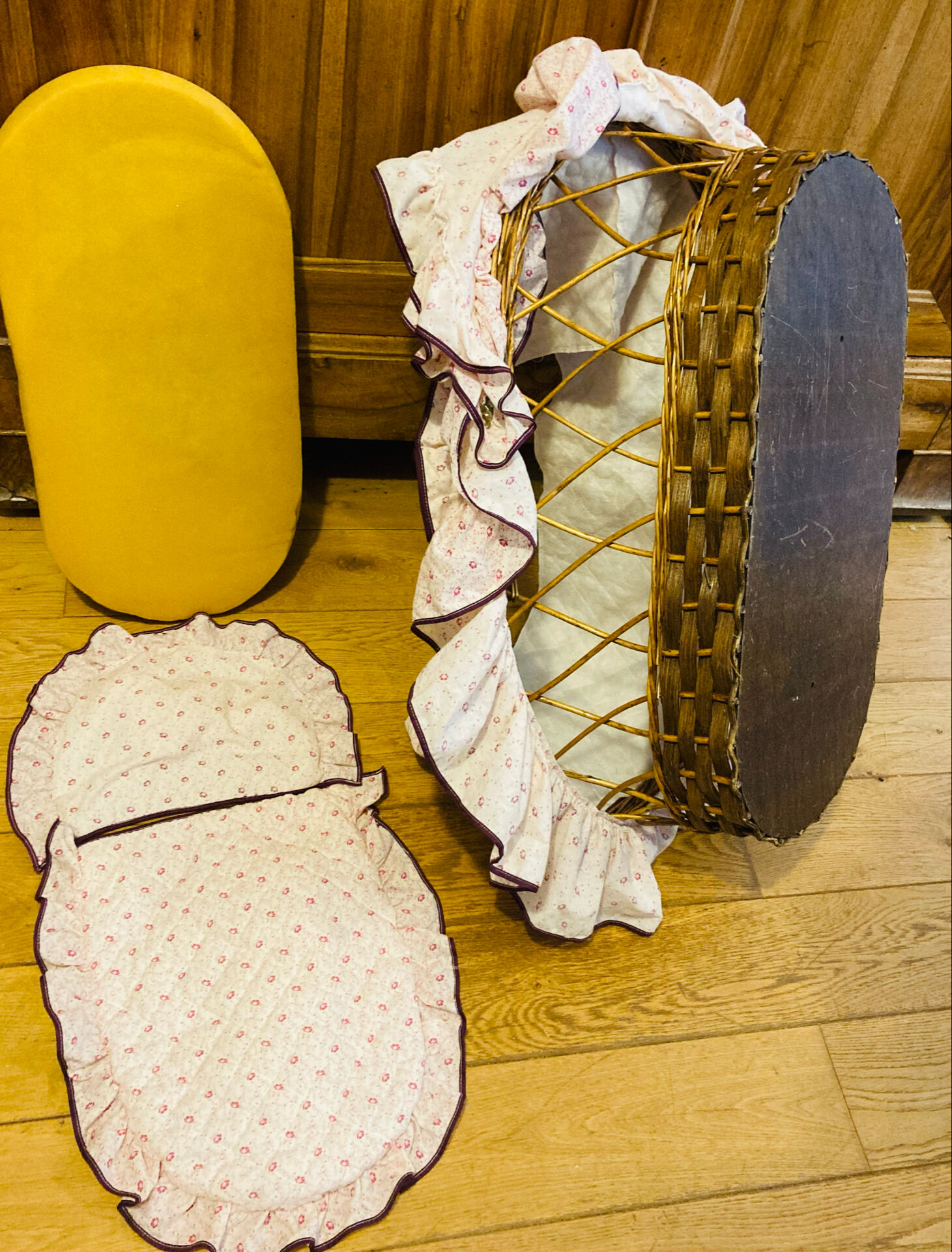 1960s wicker cradle with mattress and drapes.