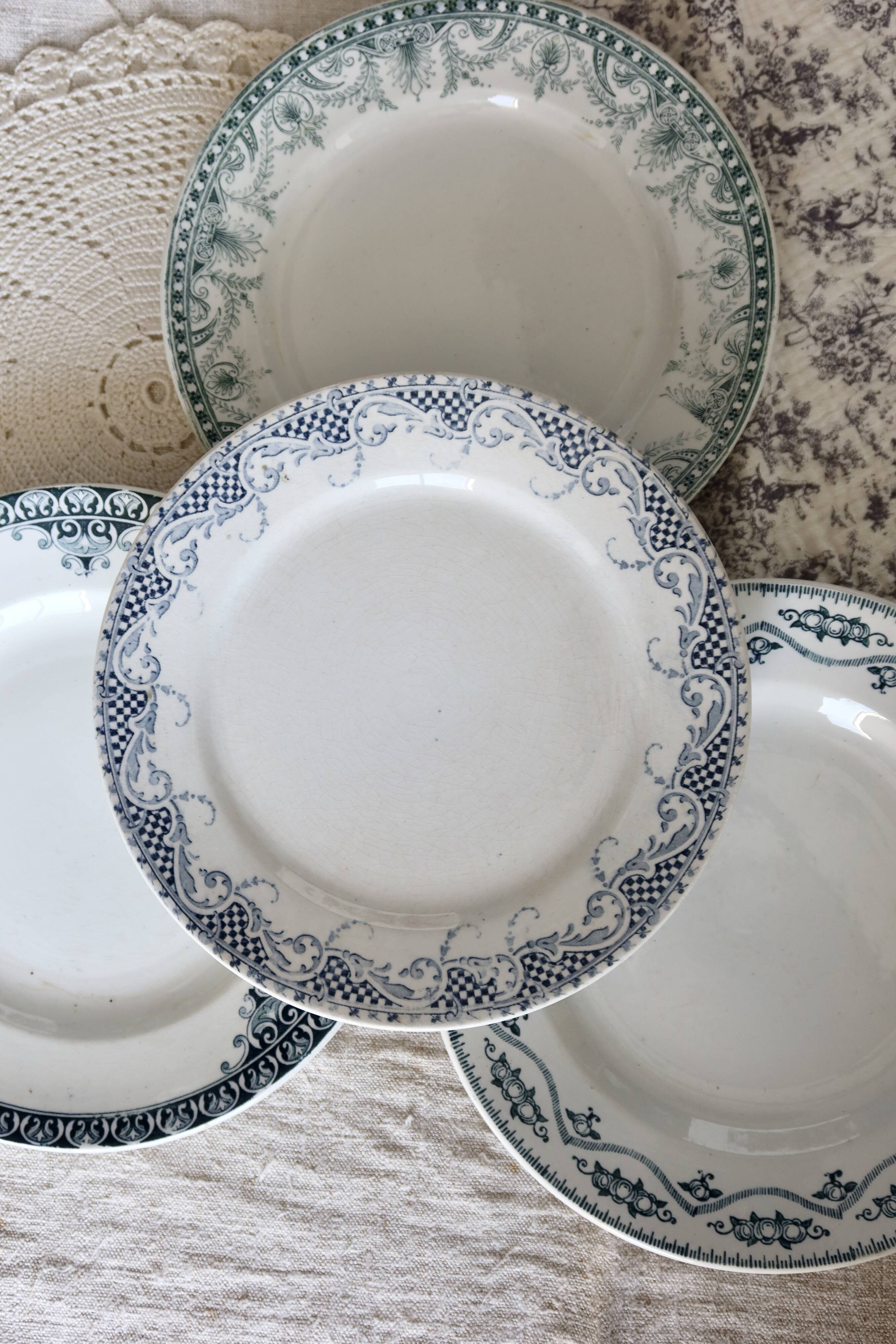 Mismatched vintage flat plates in green and blue ironstone.