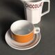 Hot chocolate cups and milk jar