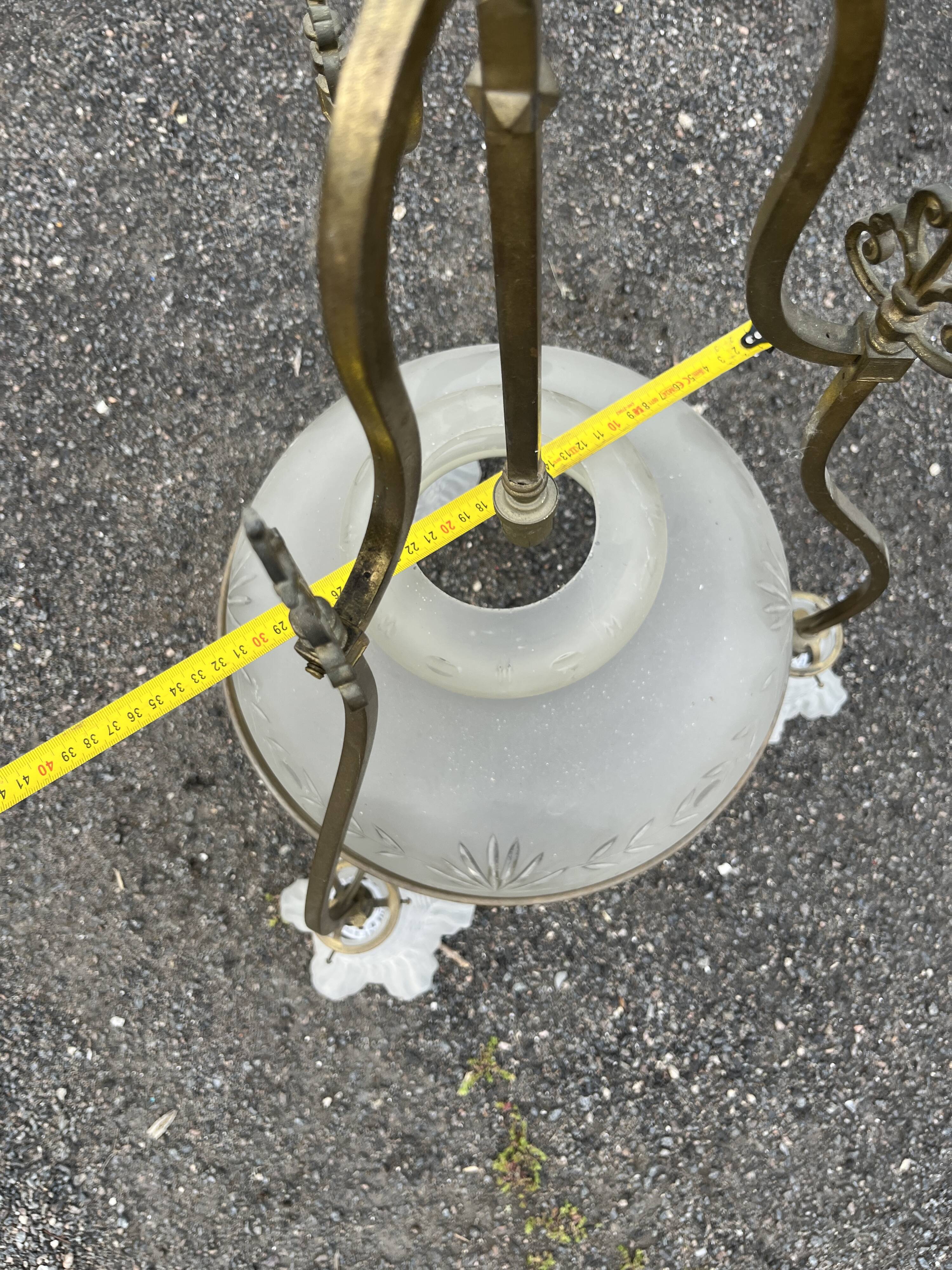 Antique brass chandelier with 3 lights and frosted glass shades.