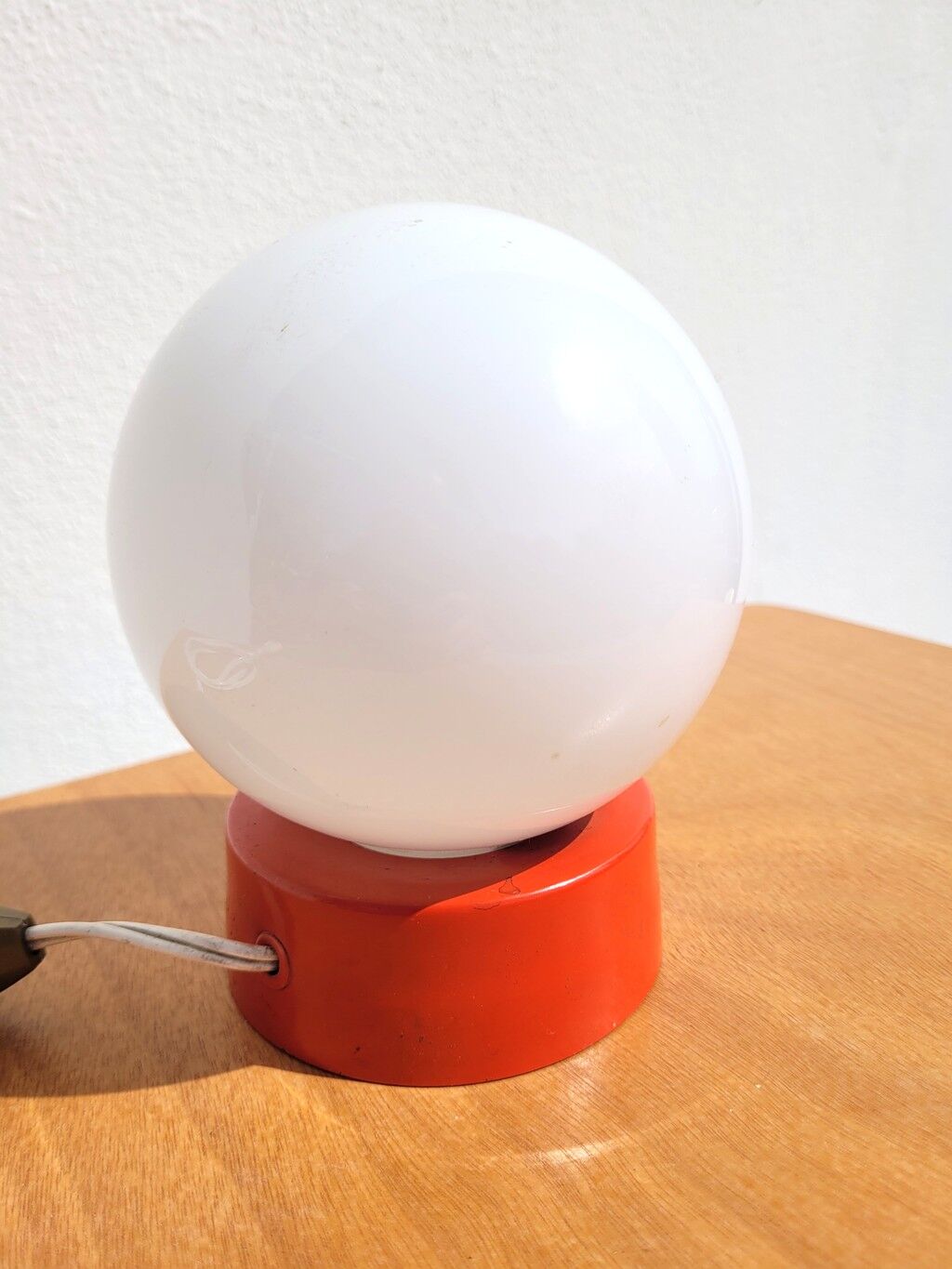 Small vintage opaline ball lamp with an orange base.