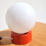 Small vintage opaline ball lamp with an orange base.