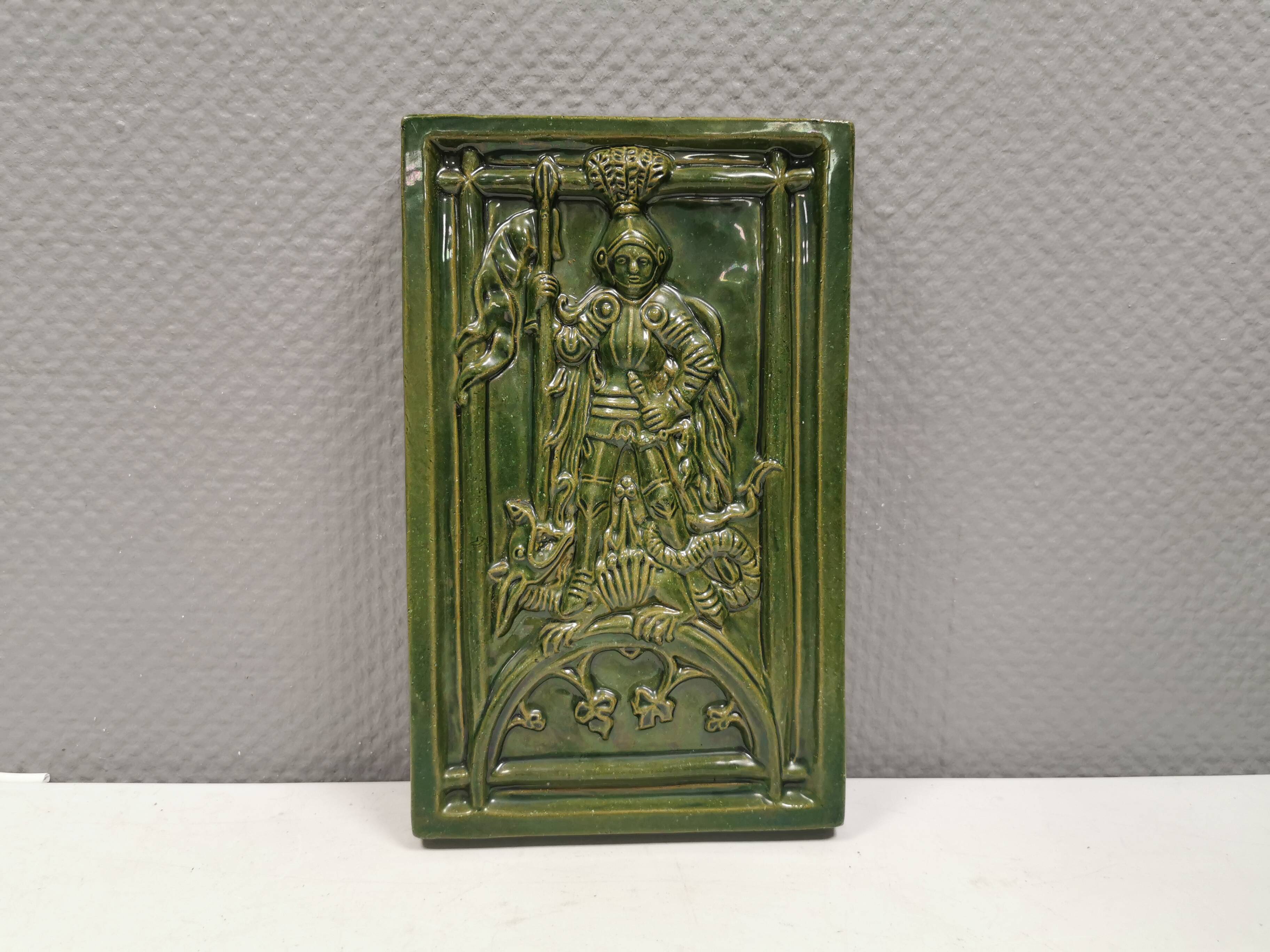 Antique tile in green faience, motif of Saint George and the dragon