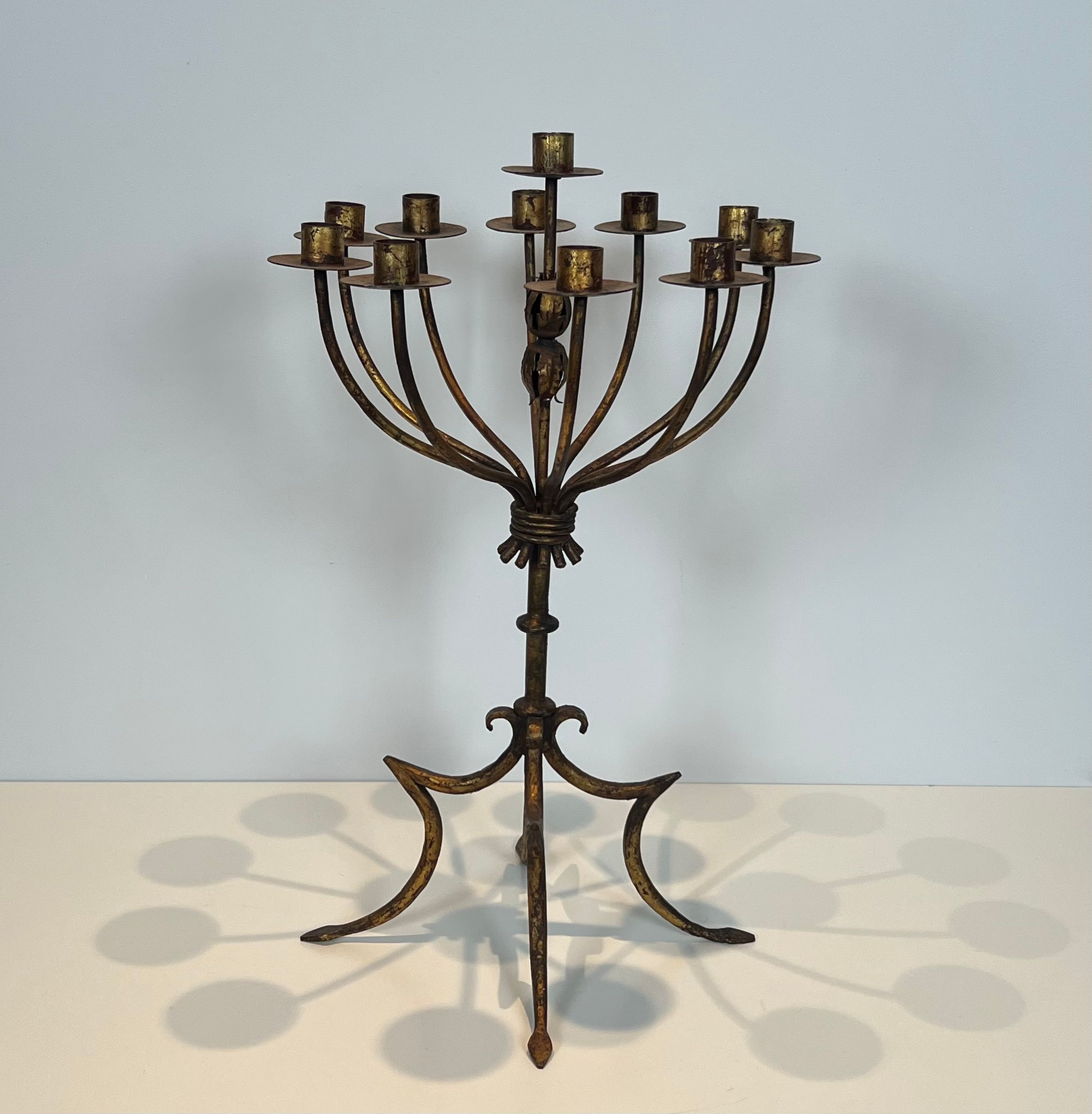 Important gilded wrought iron candelabrum with 11 arms.