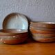Set of 10 turned stoneware plates, pyritised and glazed, wabi-sabi brutalist.