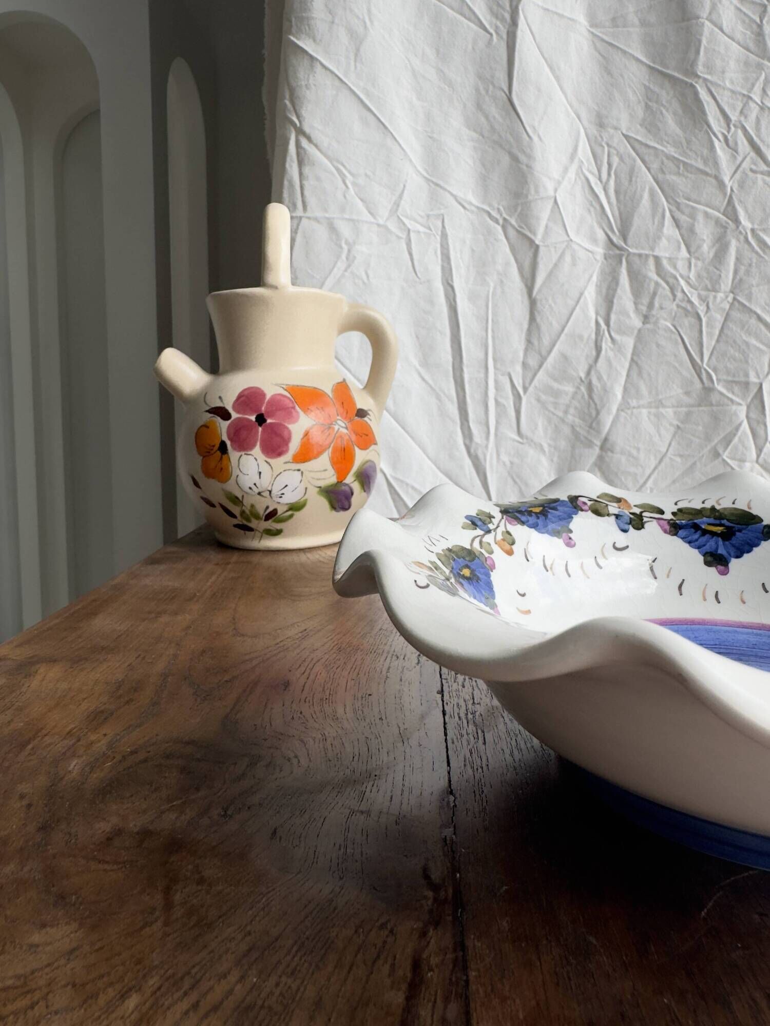 Small hand-painted earthenware salad bowl with garland of blue flowers, mark below