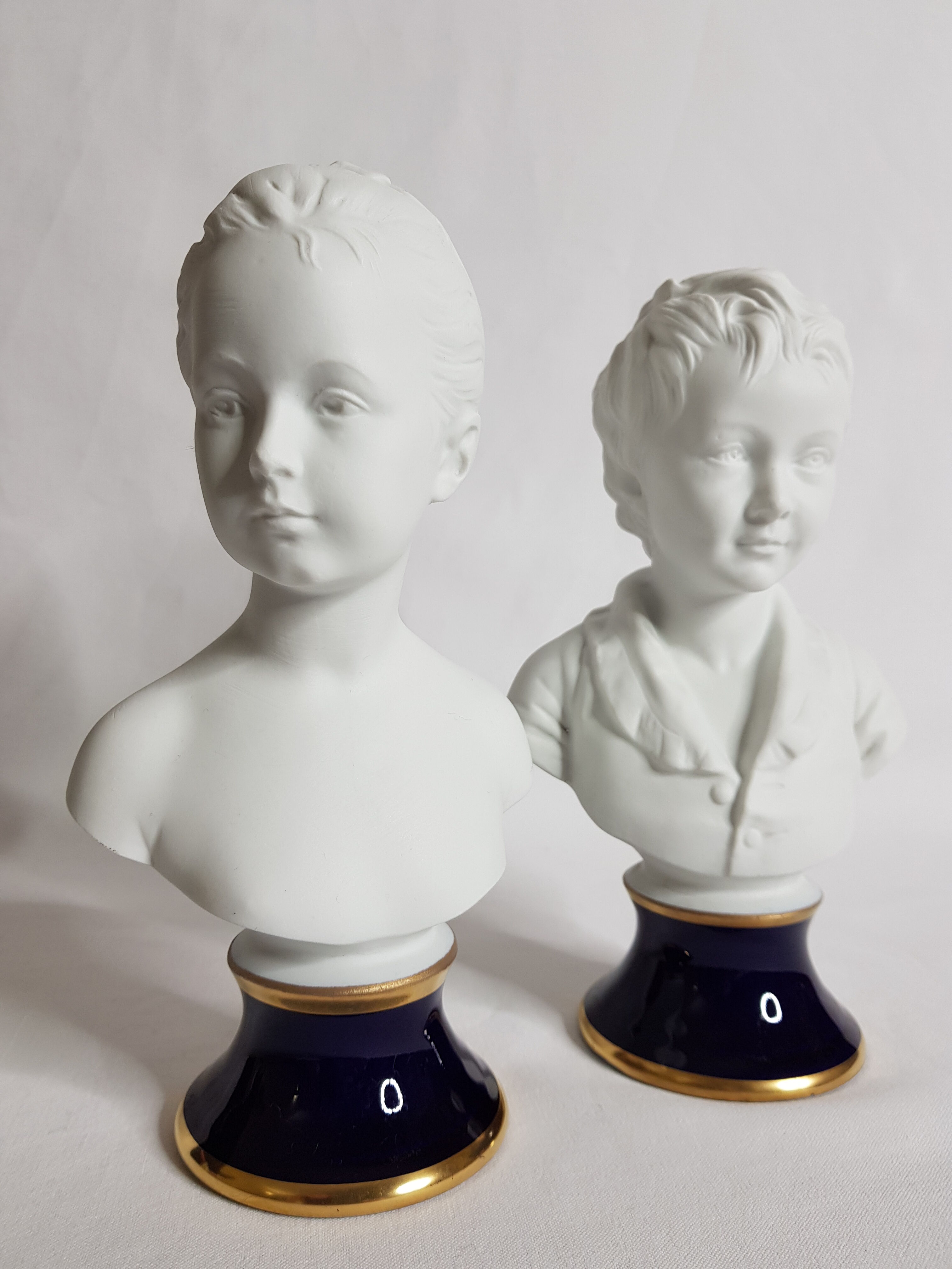 Porcelain biscuit busts by Camille Tharaud, children Louise and Alexandre Brongniart after Houdon