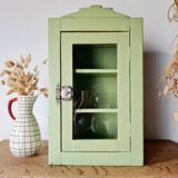 Small glass cabinet in green colour.