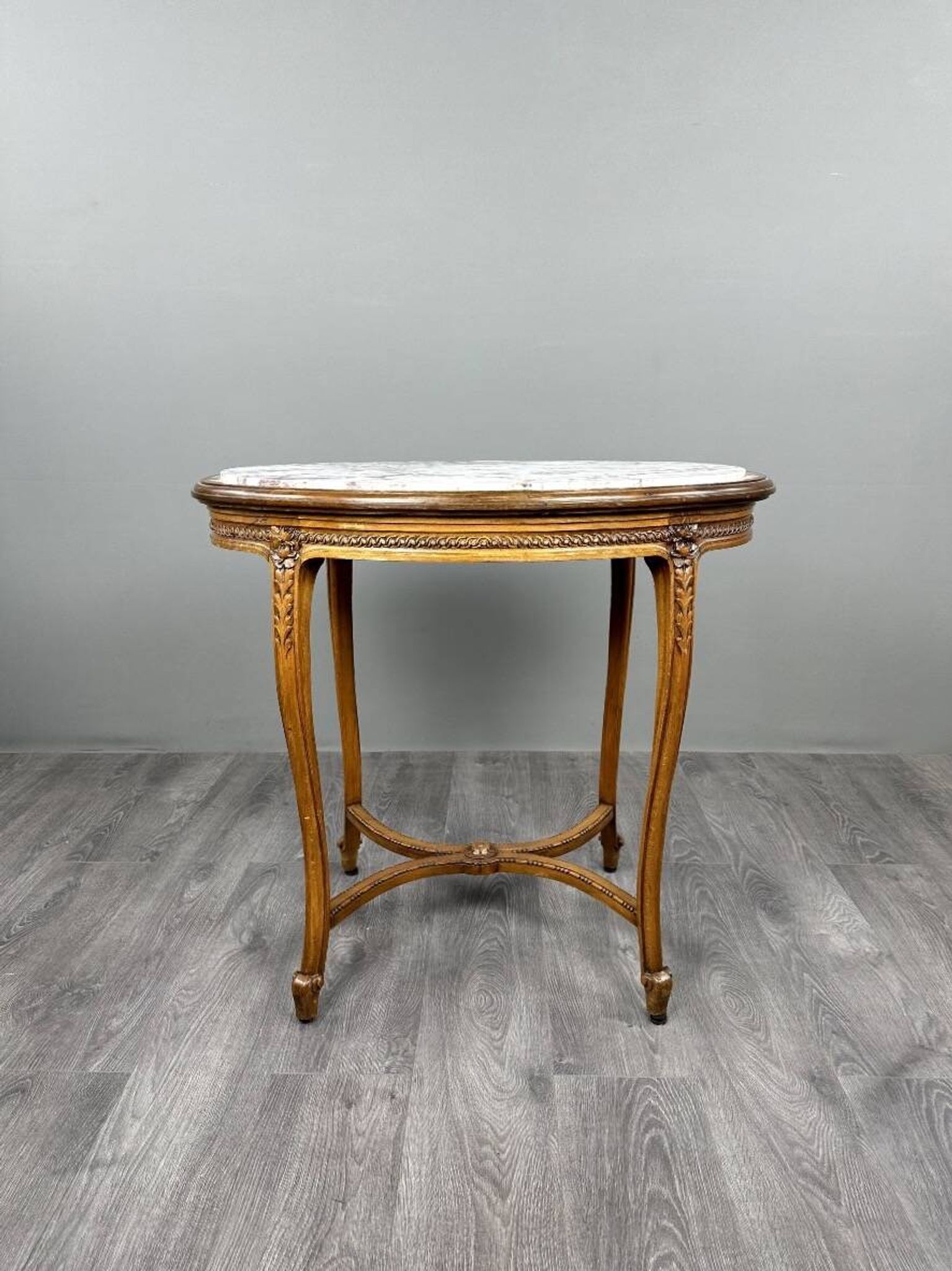 Oval guéridon table in carved wood and marble, Louis XVI style, 19th century.