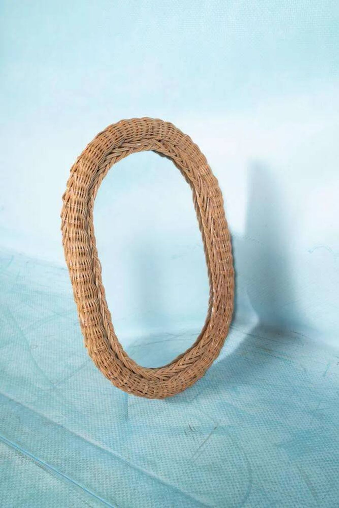 Vintage 70s bohemian wall mirror in woven rattan.