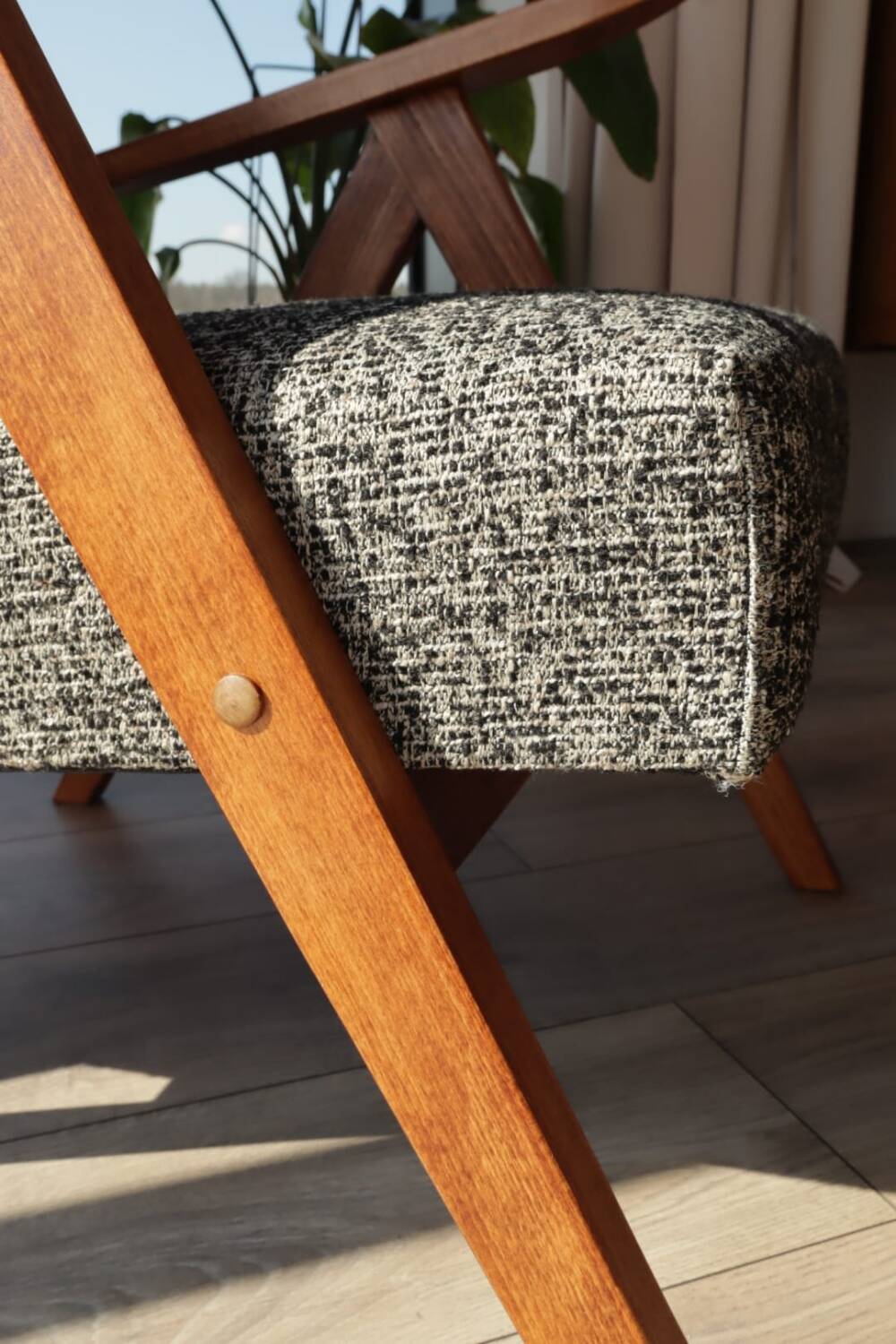 Vintage design armchair in mixed black fabric, walnut-coloured wood.