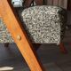 Vintage design armchair in mixed black fabric, walnut-coloured wood.