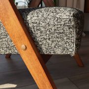 Vintage design armchair in mixed black fabric, walnut-coloured wood.