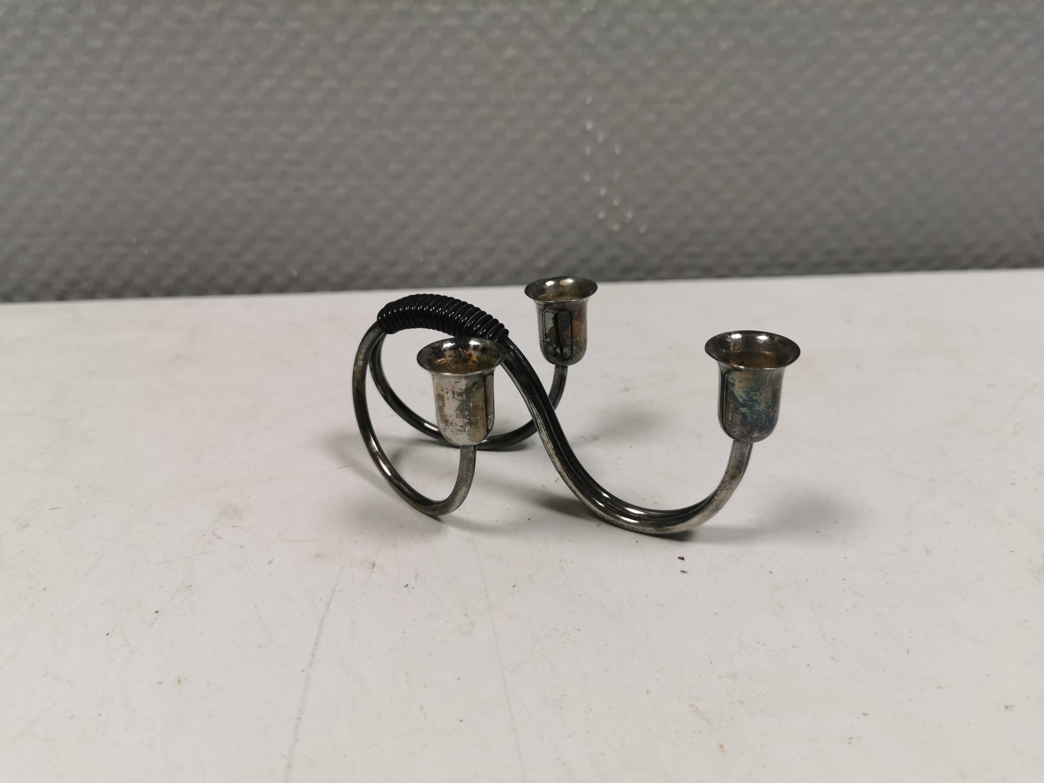 Small candle holder in tarnished silver, with place for three small candles