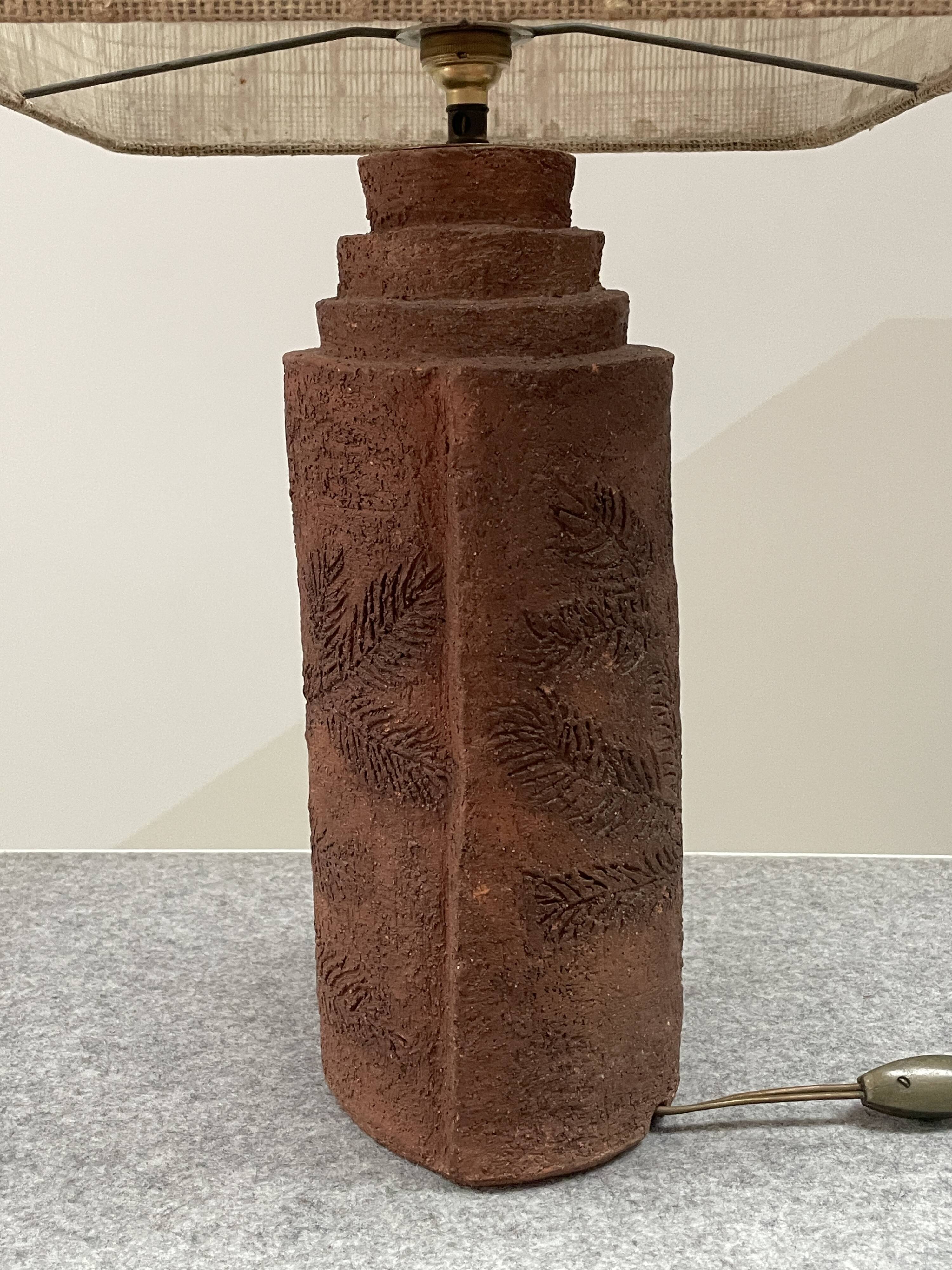 Large chamotte clay lamp in brutalist style, with a plant motif.