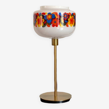 Table lamp with a vintage “flower power” glass globe and a gold base