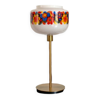 Table lamp with a vintage “flower power” glass globe and a gold base