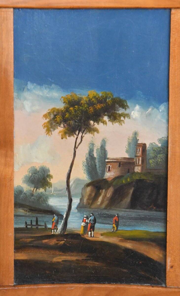 Pair of chairs with slatted backs and painted bands depicting animated landscapes.