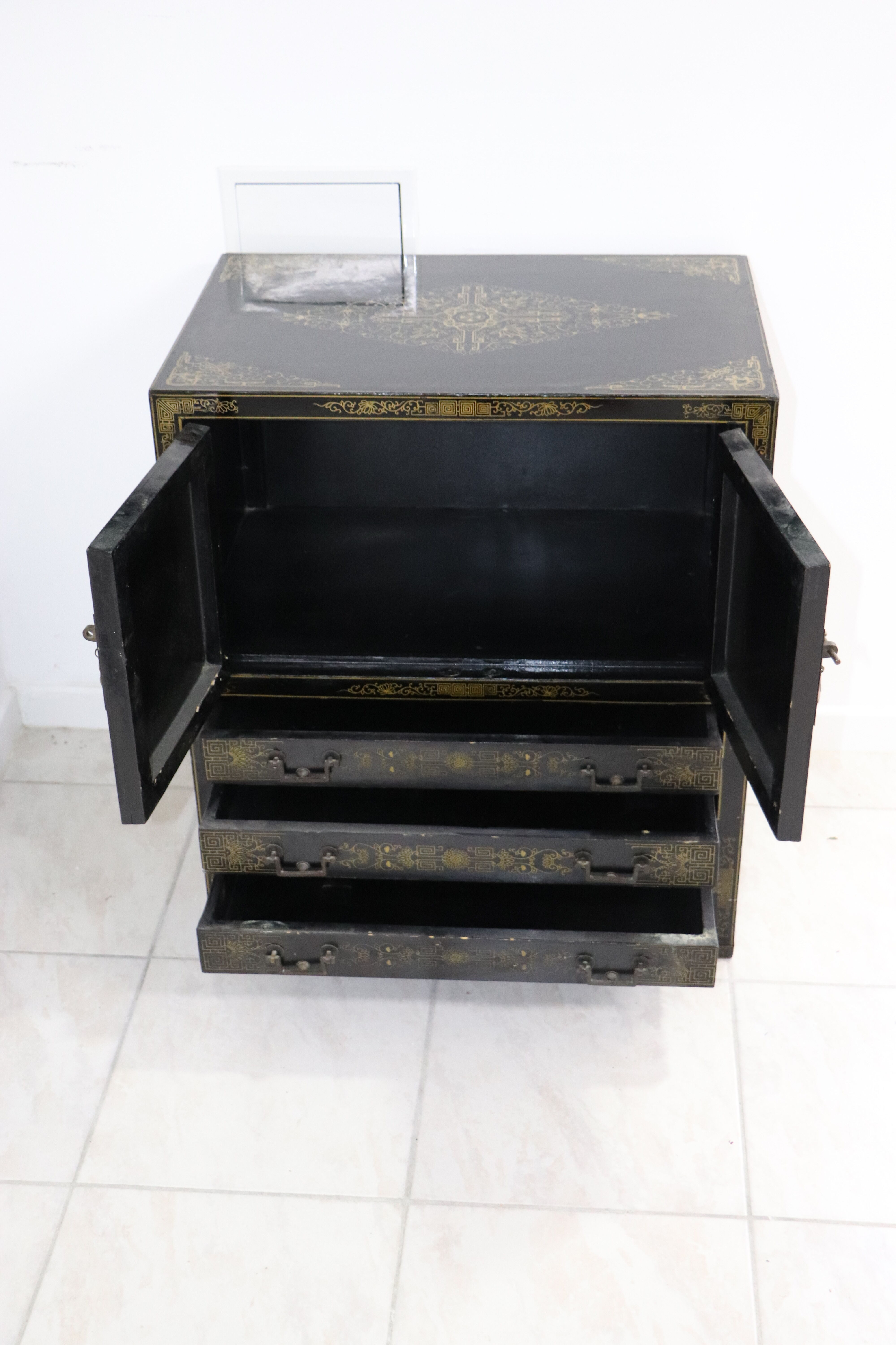 Black lacquered Chinese buffet with stone and ivory figures