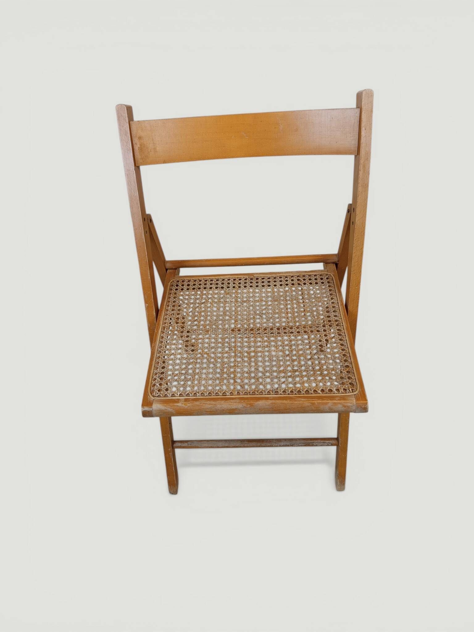 Vintage folding chair with caning.