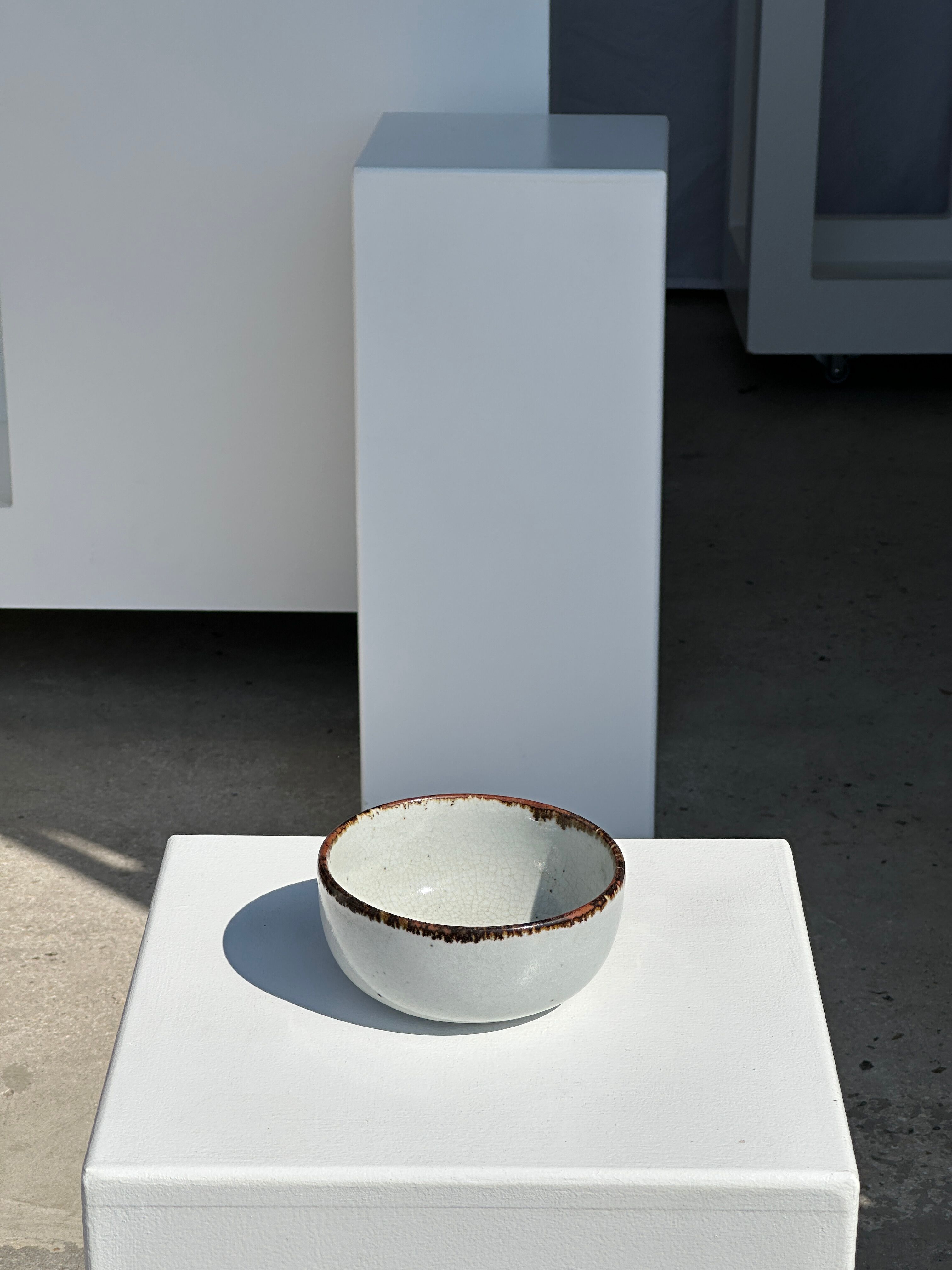 Small white glazed ceramic bowl black edges