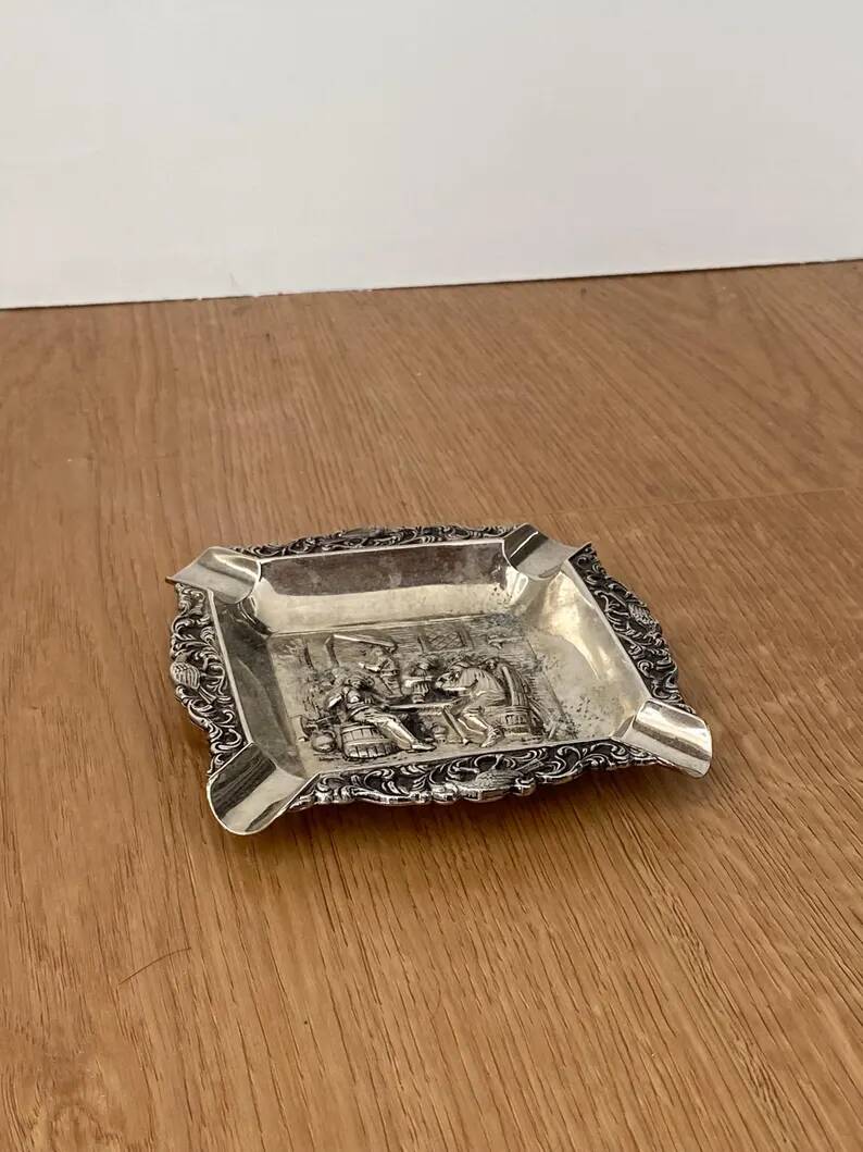 Antique silver-plated ashtray, decorated with repoussé scenes of a tavern, pin tray.