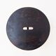 Vintage black-stained wooden tripod stool with mortise joints.