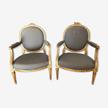 Pair of gilded medallion armchairs in Louis XVI style