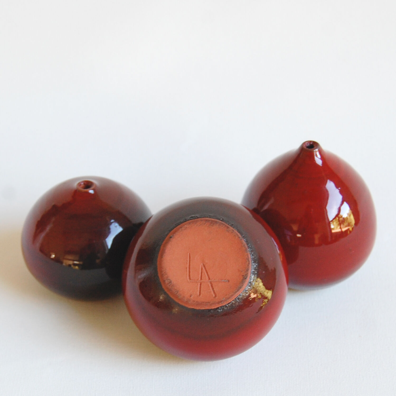 Trio of red miniature ceramics by Antonio Lampecco