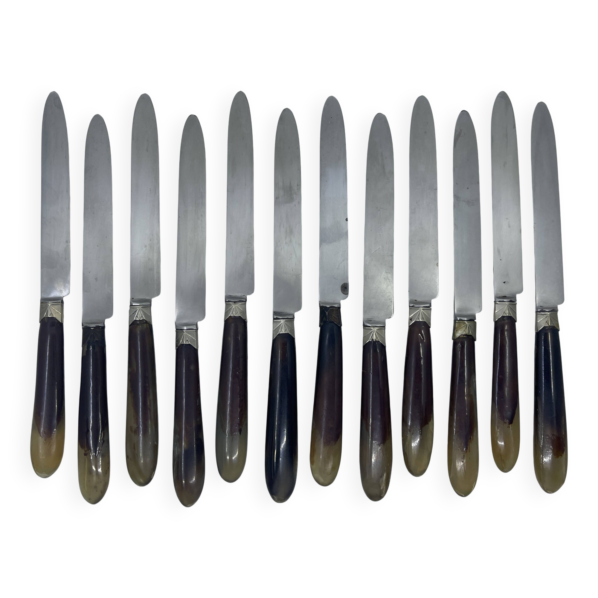 Set of 12 dessert knives with two-tone horn-effect resin handles.