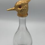 Glass bottle type carafe with gold metal bird head stopper