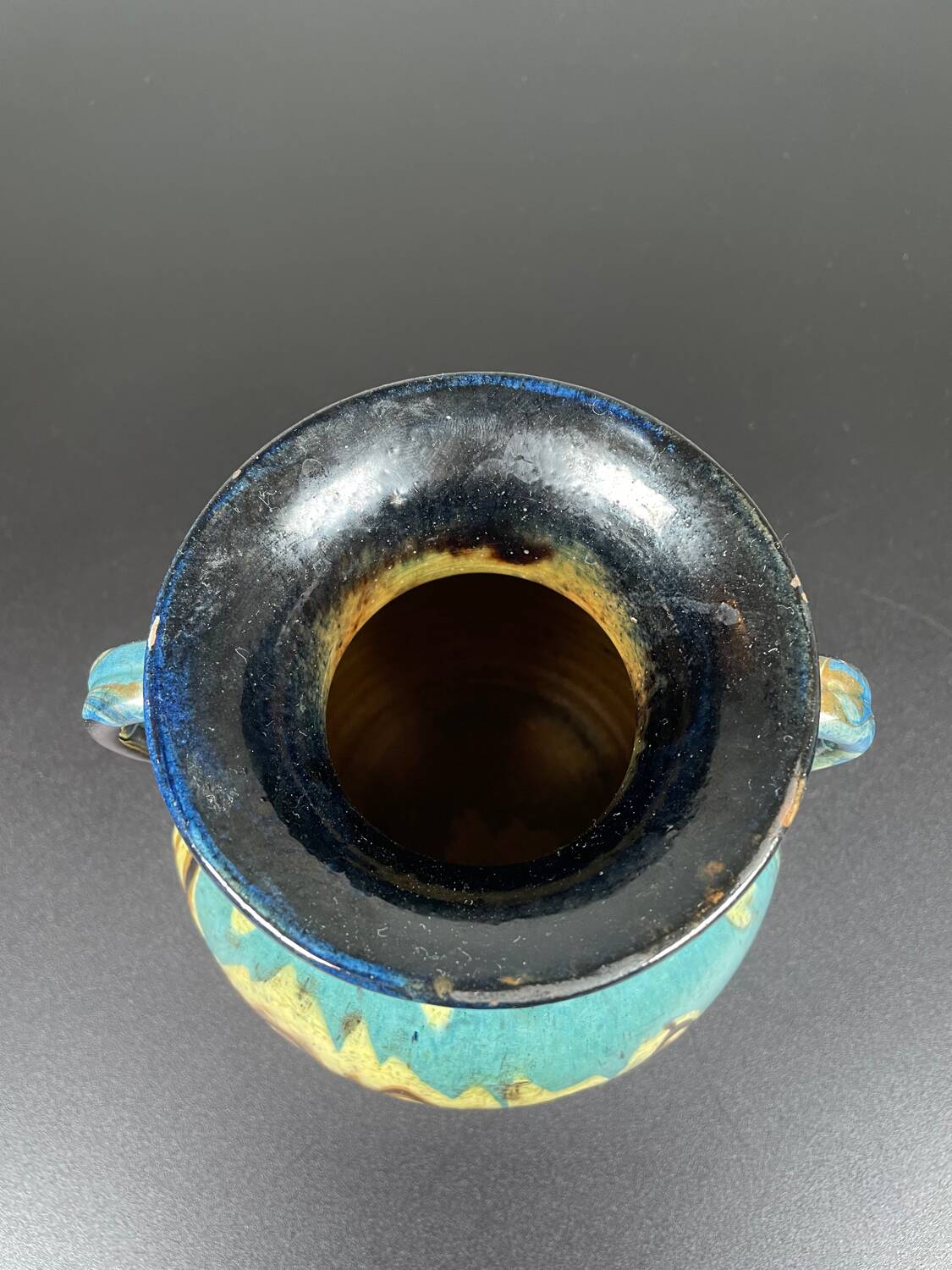 Black ball vase with handle, yellow blue marbled