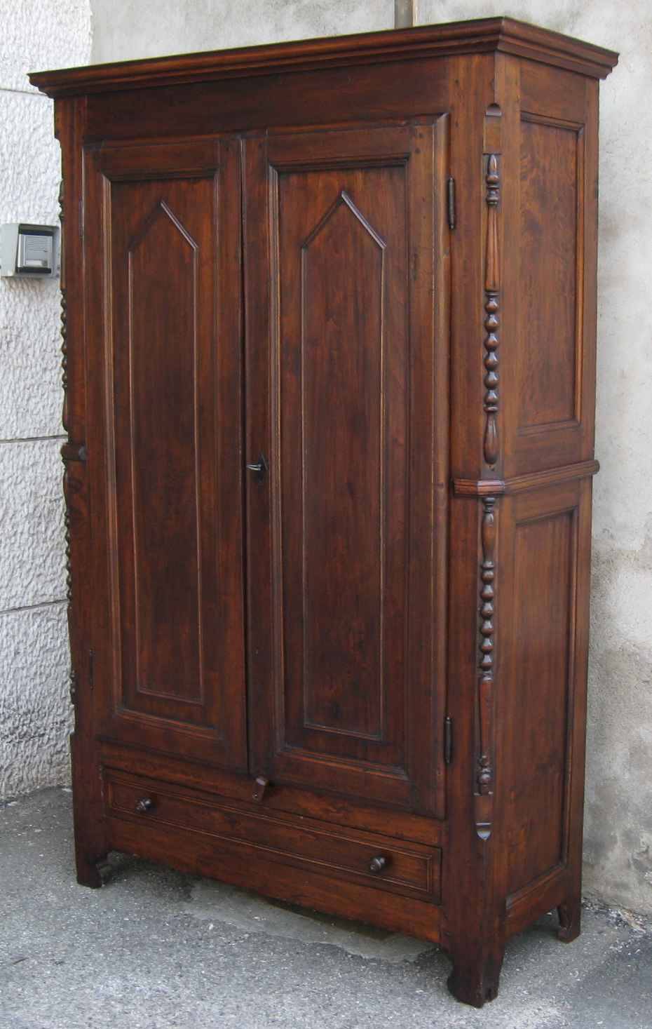 Antique solid wood wardrobe in historical rustic style from the 19th century.