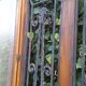 Oak entrance door and its frame and transom, wrought iron gates