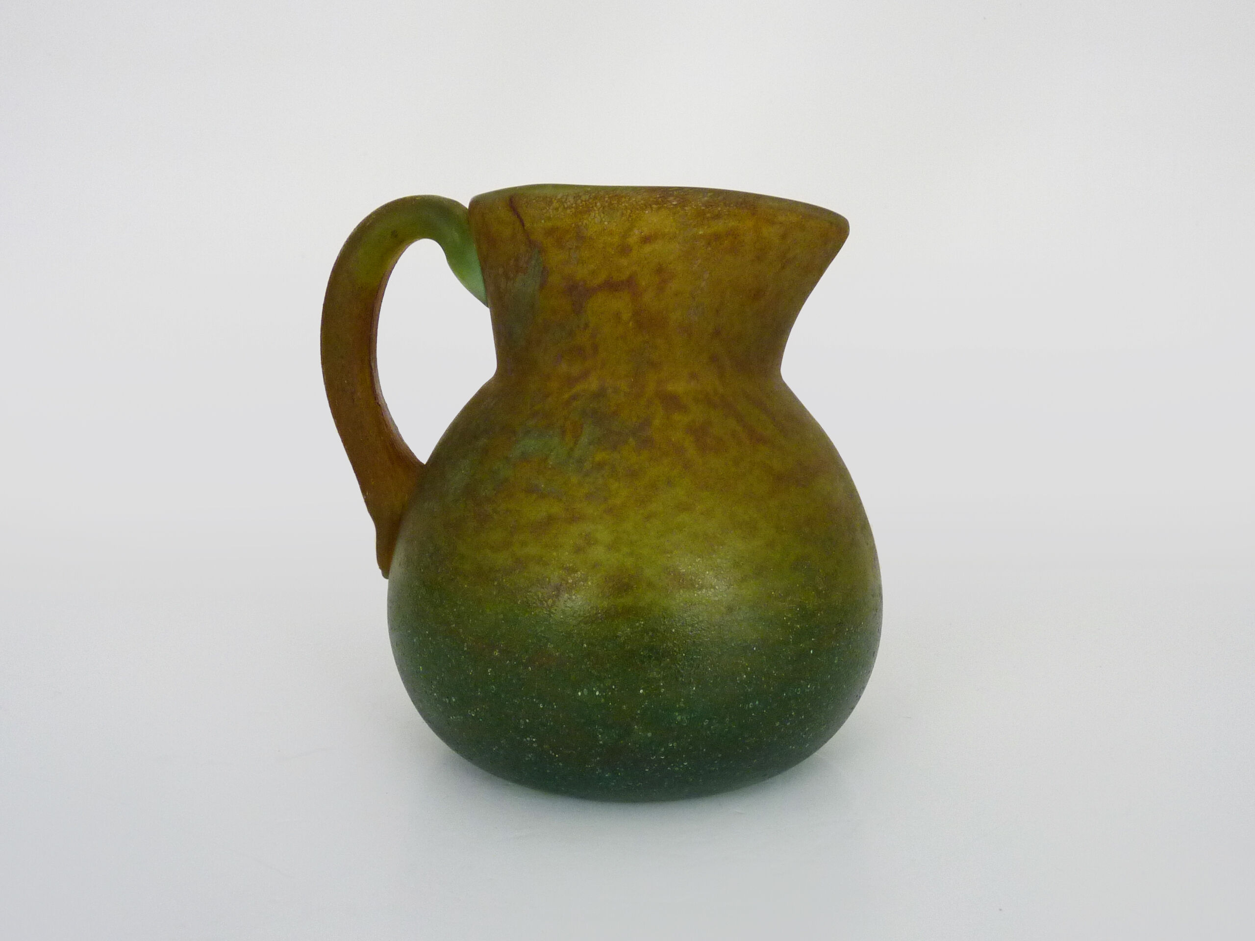 Pitcher in orange and green marble glass paste. Signed Georges De Feure for Daum