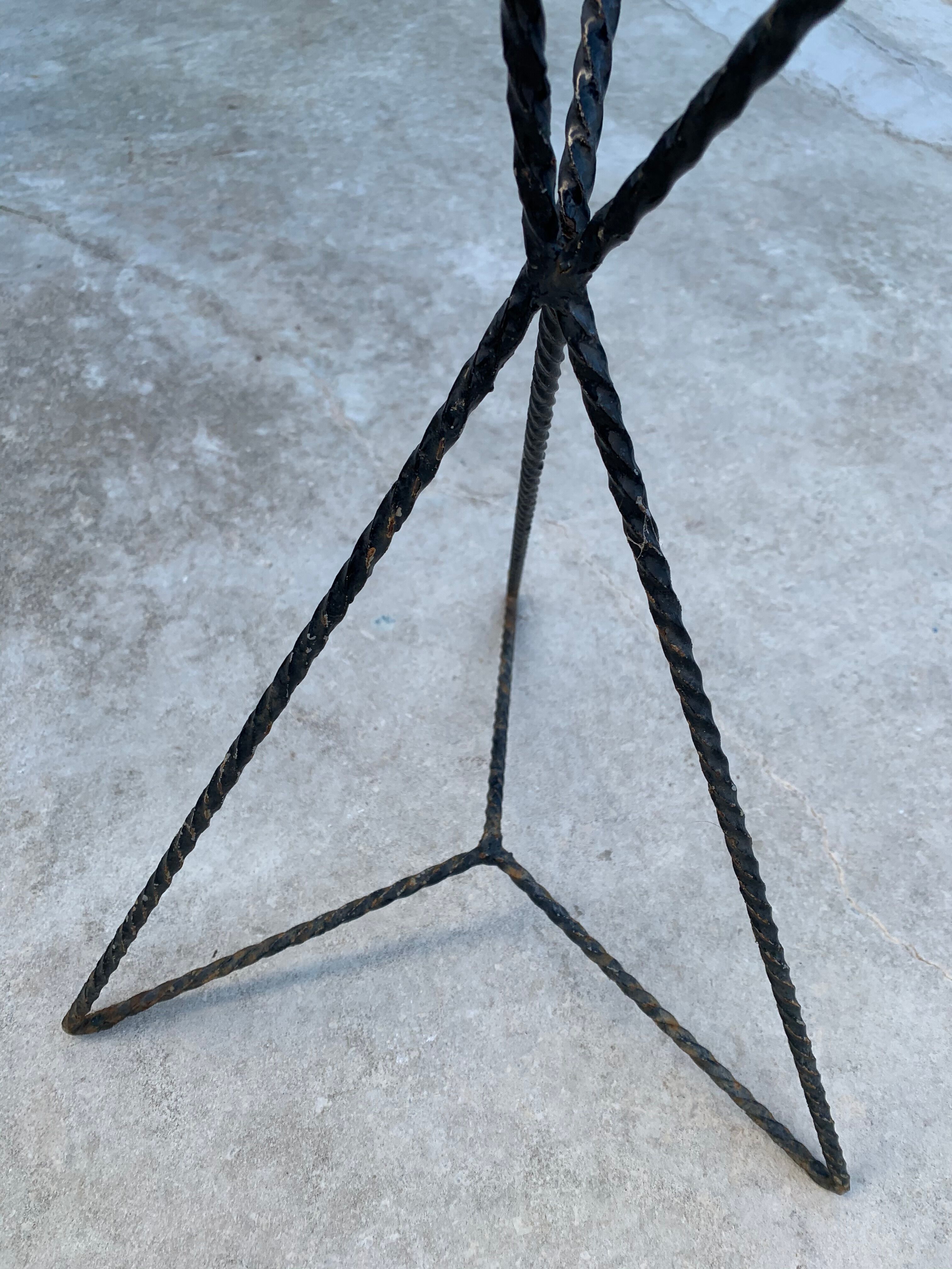 Black metal tripod plant holder