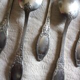 A set of 6 silver-plated metal soup spoons with foliage design.