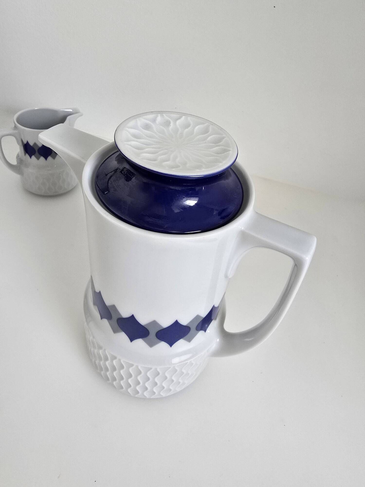 Vintage Schirnding Bavaria coffee pot and milk jug, blue geometric pattern.