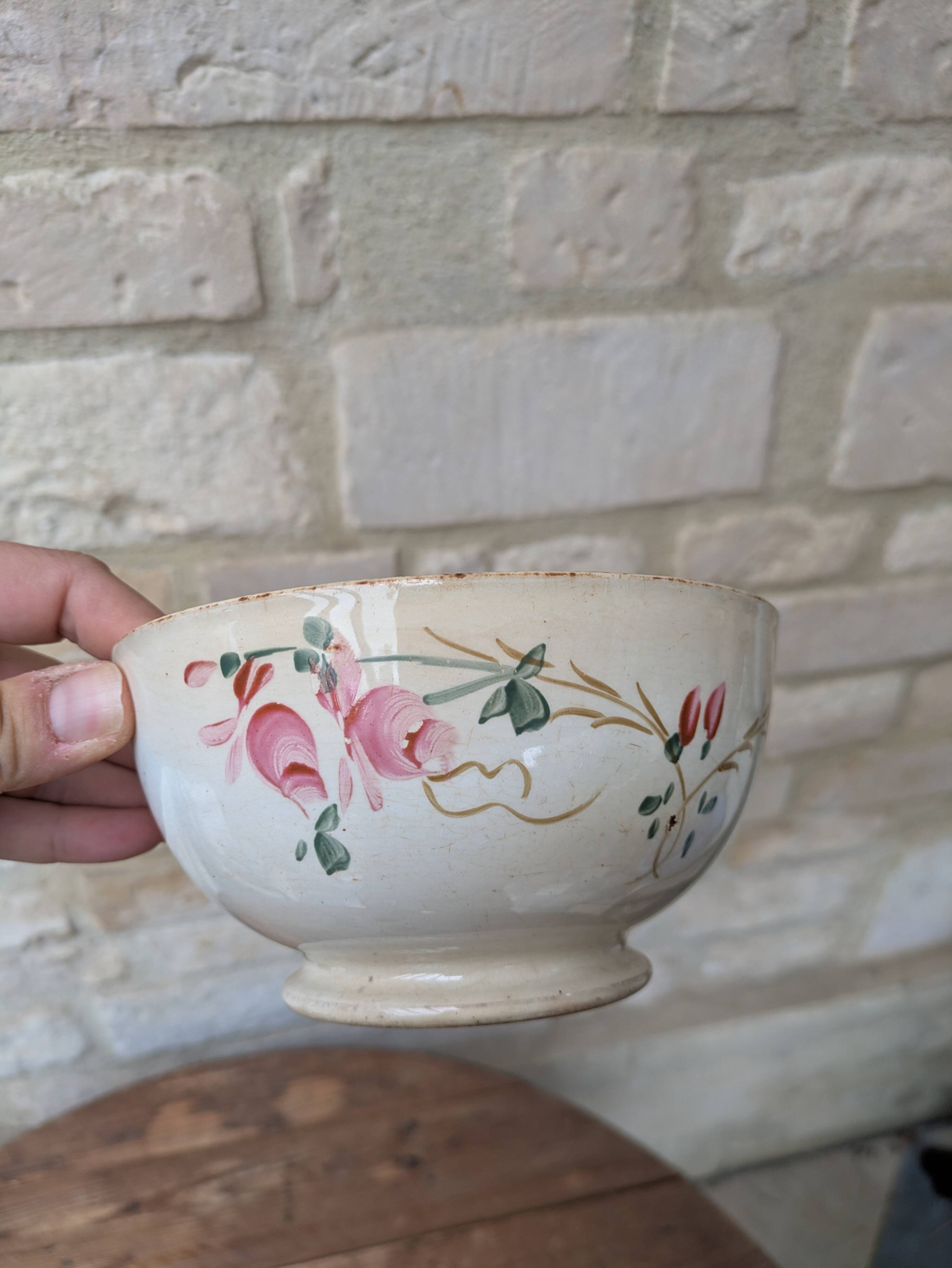 Old opaque porcelain bowl from Gien with a floral decoration.
