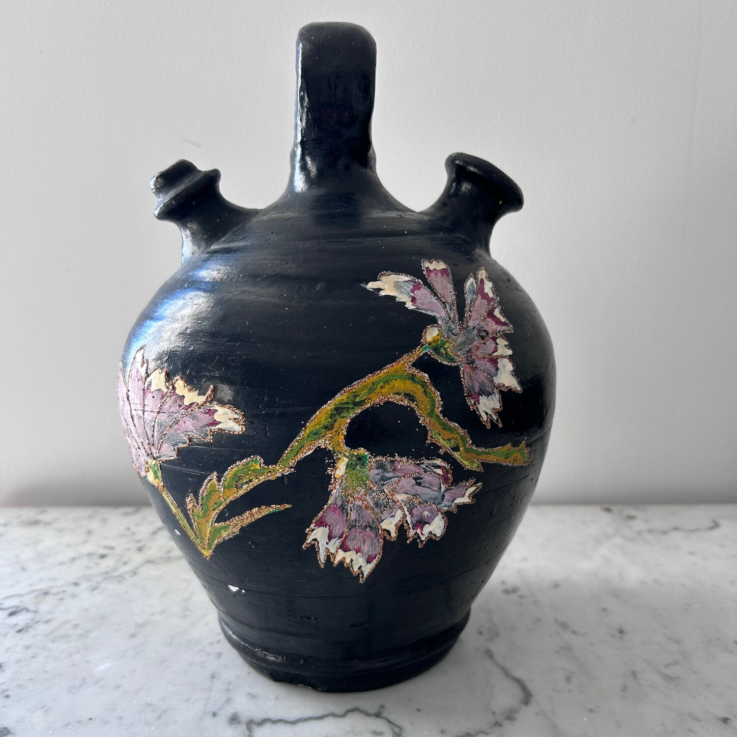 Black water jug with floral decoration