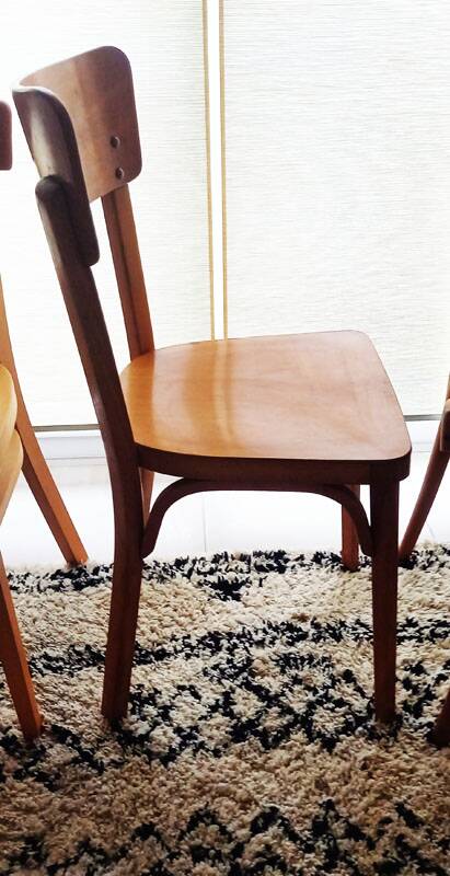 Set of 4 light wood bistro chairs stamped Baumann and Thonet.