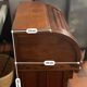 Antique solid wood secretary with a drop-down cylinder compartment.