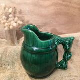 Porcelain pitcher in the shape of a barrel, with its handle that looks like a vine stock