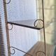 Wall shelf in metal with slanted shelves