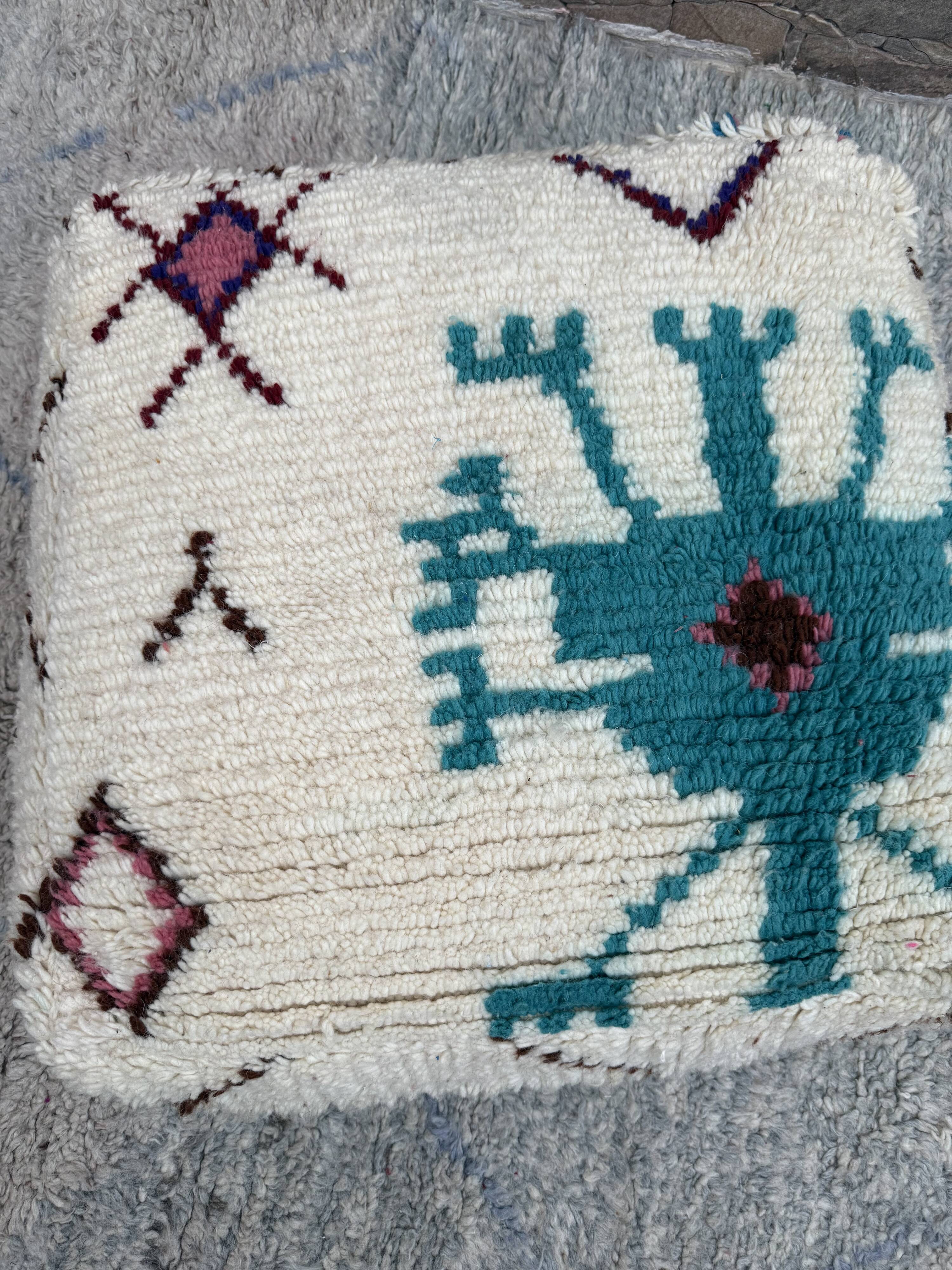 Berber floor pouf: Handwoven Moroccan wool cushion.