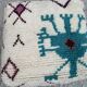 Berber floor pouf: Handwoven Moroccan wool cushion.